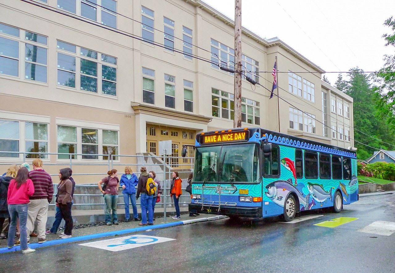 bus in front of white cliff building